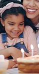 Happy family, little girl and hug for birthday cake, celebration or candles in joy for special day together at home. Mother hugging child or kid with smile for love, care or make a wish at house