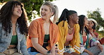 Friends, group or laughing outdoor with communication, story or gossip in summer for bonding or happiness. People, girls or sitting on a park for conversation, diversity and laughing for quality time