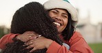 Happy woman, friends and hug for love, support or care in outdoor friendship together. Excited or friendly female person hugging with smile for trust, embrace or unity outside an urban town or city