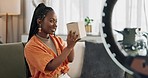 Wave, live streaming and happy black woman with box or product in home living room. Hello, influencer and person with package, record video on social media and content creation, ring light and phone