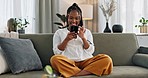 Home, funny and black woman on a sofa, cellphone and connection with social media, comedy post and laugh. African person, apartment or girl on couch, smartphone or mobile user with humor or typing