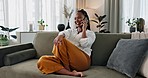 Black woman on sofa, relax and phone call for networking, conversation and connection with smile in home. Happy girl on couch with smartphone, funny discussion and online chat in living room of house