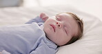 Relax, growth and sleep with a baby in a bedroom closeup in a home, dreaming during a nap for child development. Kids, calm and rest with an adorable newborn infant asleep on a bed for comfort