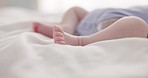 Sleeping, dreaming and feet of baby on bed for child care, resting and relax in nursery. Adorable, cute and closeup of toes of innocent newborn infant for health, wellness and development at home