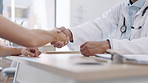 Handshake, healthcare and doctor with his patient in his office of the hospital during a consultation. Professional, closeup and male medical worker shaking hands with a woman in a medicare clinic.