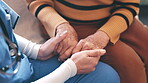 Senior, woman and nurse with holding hands for empathy, support and compassion on sofa of nursing home. Elderly, person or professional caregiver with sympathy, consulting and kindness for retirement