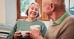 Old, couple or tea talk in retirement home for love connection, pensioner relax together or morning routine. Man, woman and hot drink on sofa trust support communication, marriage calm or happy peace