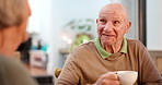 Tea party, elderly friends and conversation with people in a retirement home together for bonding in the morning. Smile, drink and a group of happy seniors chatting in the living room of an apartment