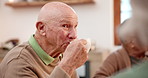 Tea party, elderly friends and conversation with an old man in a retirement home together for bonding in the morning. Smile, drink and a group of happy seniors chatting in the kitchen of an apartment