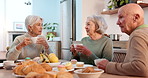 Breakfast, senior friends and conversation with people in a retirement home together for bonding in the morning. Tea party, drinking and a group of seniors chatting in the living room of an apartment