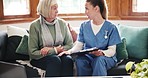 Nurse, checklist and senior woman in home living room for advice, consultation and help on couch. Caregiver, elderly person and clipboard for report, results or medical history for healthcare on sofa