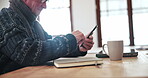 Senior, man and phone with scroll for social media, reading news article or internet website at table in lounge. Elderly, person and smartphone or technology for notification or online search at home