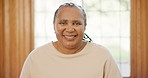 Smile, face and senior woman at her home with positive, good and confident attitude in living room. Happy, portrait and elderly African female person in retirement stand in the lounge of modern house