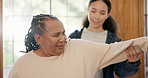 Senior woman, physiotherapist and rehabilitation for arm, stretching and exercises for recovery. Black female person, nursing home and assistance or support, assessment and checkup for healthcare