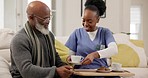 Breakfast, caregiver or old man in retirement on a sofa in living room, house or nursing home. Black people, wellness or nurse serving morning meal or food to a hungry elderly patient for healthcare