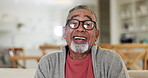 Face, smile and glasses with a senior man in the living room of a retirement home to relax on the weekend. Portrait, funny and eyewear with a happy elderly person laughing at a joke in his apartment