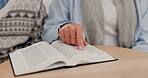 Man, hand and bible study on table with priest with religion book, spiritual growth or hope prayer in home. People, god or christian reading for worship or healing, jesus christ or learning in house