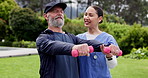 Nurse, outdoor and dumbbells for man in retirement for health, wellness and training for muscle rehabilitation. Physiotherapist woman, senior patient and together in garden, fitness or weightlifting