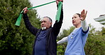 Physiotherapist, senior man and resistance band for stretching, fitness or training for wellness. Nurse, elderly patient and support for rehabilitation in garden, outdoor or park for health in nature