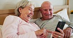 Couple, together and phone for funny on bed with social media, post or meme for reading. Senior man, woman and showing of message, scroll and read by internet, web or cell for joke with laugh in bond