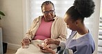 Nurse, pills and mature black woman drinking water, support and healthcare in home. Caregiver, medicine of patient and glass for drugs, supplements or prescription, medication and help with capsule