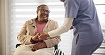 Old woman, wheelchair and caregiver by holding hands in nursing home in trust, support or help. Elderly patient, glasses and nurse with talk, assistance and mobility for doctor appointment for health