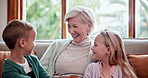 Happy, love and children hugging grandmother on a sofa in the living room at modern home. Smile, bonding and young kids embracing senior woman in retirement with care in the lounge of house.