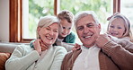 Smile, love and children hugging grandparents on sofa in the living room at modern home. Smile, bonding and portrait of kids embracing senior man and woman in retirement with care in lounge of house.