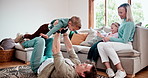 Happy, playing and children with parents on a sofa in the living room at modern home together. Smile, playful and kids bonding with mother and father for airplane in the lounge at family house.