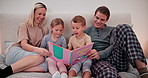 Parents, kids and reading books in bedroom for learning, language development and educational knowledge. Happy mother, father and children relax for bedtime, storytelling and together in family home 