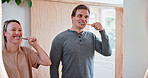 Couple, bathroom and brushing teeth in mirror with smile for hygiene, morning routine and healthy oral habits. Happy man, woman and reflection at home with toothbrush, dental cleaning or fresh breath