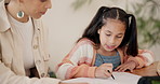 Mother, child and writing in book for maths homework, education or learning together in bonding on desk at home. Parent and daughter explaining notes in notebook, study or mathematics lesson at house