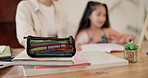 Homework, stationery and child with parents in home for education, learning and school lesson. Family, creative student and mother with young girl and notebooks for writing, knowledge and studying