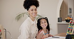 Mother, daughter and face for homework with happiness, math and learning for education at dining table. Family, woman and girl child with portrait, homeschooling and smile in lounge of home with love