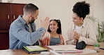 Parents, daughter and homework with high five, helping and learning support at dining table of home. Family, man or woman with girl child, happiness and education in living room of house or apartment