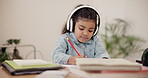 Girl, child and writing with headphones or book in education, learning or homework at house. Female person or little kid thinking with headset or notebook in creative development or elearning at home