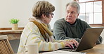 Senior couple, discussion and laptop for budget, planning investment portfolio and financial assets at home. Man, woman and computer for online banking, insurance policy and check retirement savings 