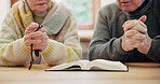 Hands, senior couple and bible for praying, faith and worship Jesus Christ, holy spirit and God at home. Closeup, rosary and reading gospel books for christian prayer, gratitude or spiritual religion