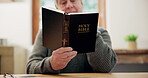 Hands, man and reading bible in home for prayer, faith and worship Jesus Christ, holy spirit and God in retirement. Closeup, senior and gospel books for knowledge, spiritual religion and christianity