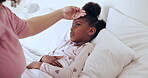 Sick, hands and girl child with touching to check or monitor wellness on bed in bedroom of home. Healthcare, woman or mother for medical support, help or care for ill kid with flu, fever or virus
