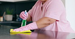 Woman, cloth and spray for cleaning of kitchen to wipe dust, dirt or bacteria on table for hygiene. Person, hand or housekeeping for disinfectant, detergent or sanitizer with rubber gloves in closeup