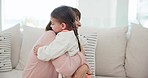 Hug, love and mother with child on sofa for bonding, healthy relationship and care at home. Happy family, parents and young girl embrace mom on couch for trust, support and affection in living room
