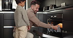 Family, baking and a father with his son in the kitchen to remove fresh bread from the oven. Children, love and a dad teaching his young boy child hot to bake while cooking in their apartment