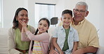 Happy, face and children with grandparents on sofa in the living room together at home. Smile, bonding and kids relaxing with grandmother and grandfather on a couch in the lounge at modern house.