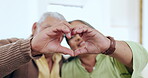 Senior couple, heart and hands for love in home for care, kindness and bonding together. Closeup of man, woman and romance sign, peace emoji or connection, support or commitment to marriage or trust