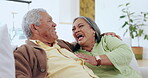 Love, smile and a senior couple laughing on a sofa in the living room of their home together. Happy, retirement or funny humor with an elderly man and woman joking or bonding in their apartment