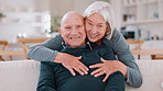 Face, hug and home with old couple, love and happiness with retirement, marriage and romance. Portrait, elderly woman and senior man on a couch, embrace and romantic with support or bonding together 