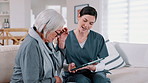 Tablet, healthcare and nurse with senior woman on a sofa in the living room of nursing home. Digital technology, medical consultation and female caregiver talking to elderly patient at modern house.