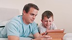 Father, child and boy with tablet in bedroom for online games, download multimedia and reading ebook story. Happy, dad and kid streaming cartoon, movies and digital technology for elearning at home 