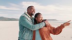 Happy couple, together and vacation by pointing on beach with embrace, sea and ocean view. Man, woman and married for holiday, trip or travel to Cape Town for relax, love and romance in relationship